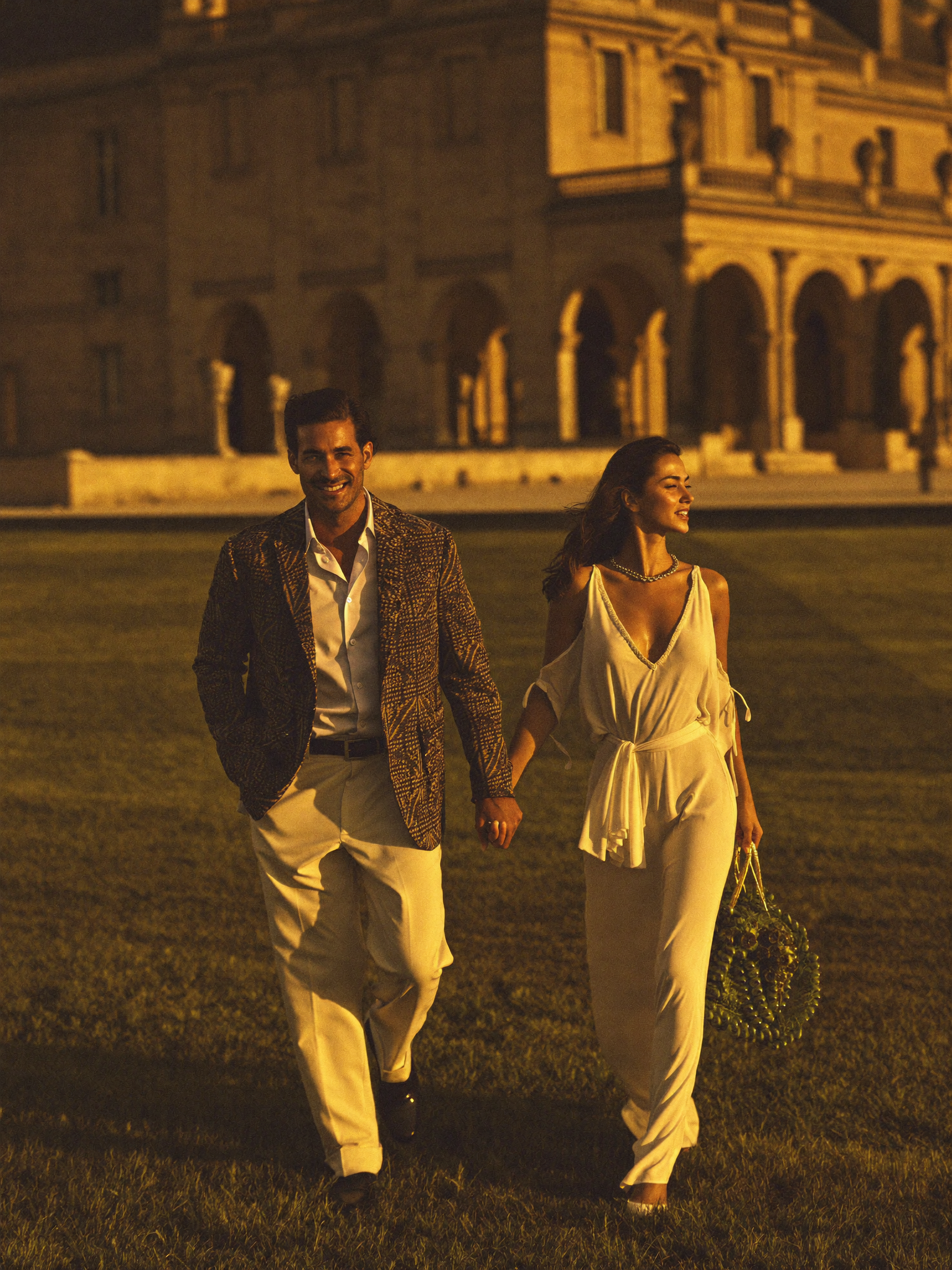 An affluent couple walking in ease across the grounds of a grand estate at golden hour, confidence and abundance